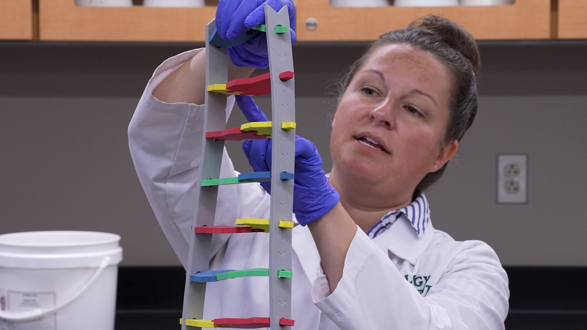 Dr. Sarah Finch holding DNA demo