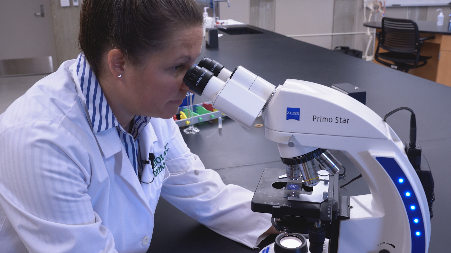 Dr. Sarah Finch using Microscope